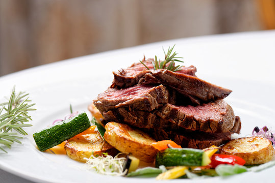 Grilled Sliced Roast Beef On Potato And Salad