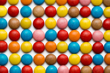 Close up of a pile of colorful chocolate coated candy, chocolate pattern, chocolate background