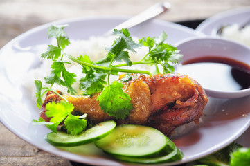 Vietnamese broken rice or com tam with fried chicken legs, pork and herbs