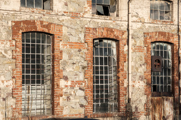 Glass iron windows of old grunge abandoned vintage industrial building