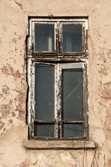 Shabby dirty grunge window of neglected and abandoned old industrial building