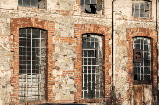 Glass iron windows of old grunge abandoned vintage industrial building