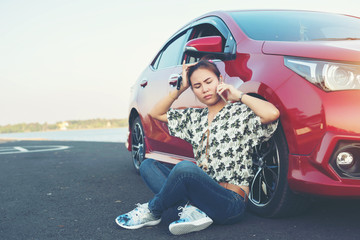 young woman playing mobile on the road