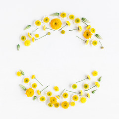 Flowers composition. Wreath made of various yellow flowers on white background. Flat lay, top view