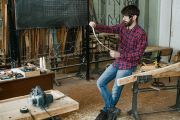 carpenter checking blueprint in workshop