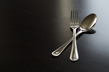 Cutlery on a black background. Fork, spoon, knife.