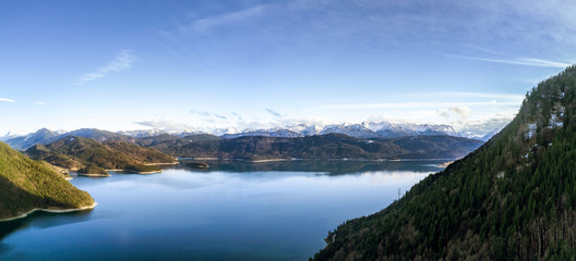 Naklejka na ściany i meble Aerial Panorama of an alpine lake with mountains