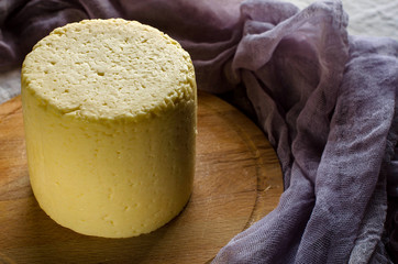 Head farmhouse cheese on wooden round Board