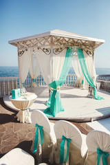 Wedding arch in Tiffany color on the beach.