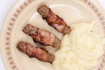 Grilled kebabs in bacon with mashed potatoes