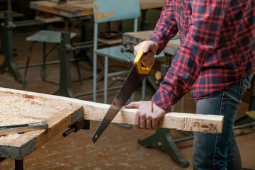 Carpenter working with a saw in workshop