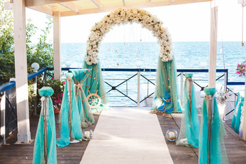 Wedding on the beach. Beautiful wedding arch, decorated with flowers. Sea. The ocean.
