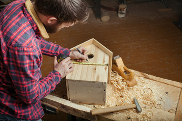 carpenter making wooden nest box