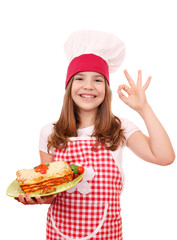 happy little girl cook with Italian lasagne and ok hand sign