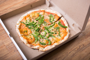 Italian pizza with green pepper in paper box tasty macro picture useful for background