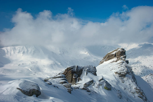 rock covered with snow and fog - Powered by Adobe