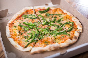 Italian pizza with green pepper in paper box tasty macro picture useful for background