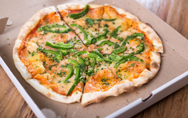 Italian pizza with green pepper in paper box tasty macro picture useful for background