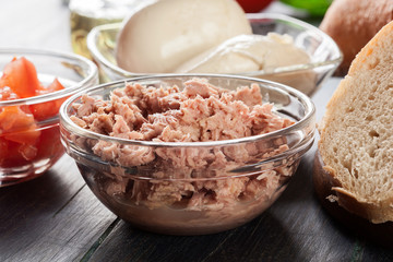 Ingredients ready for preparing bruschetta with tuna, mozzarella cheese and tomatoes