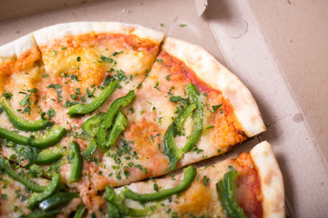 Italian pizza with green pepper in paper box tasty macro picture useful for background