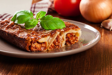 Baked cannelloni with minced meat and bechamel sauce on a plate