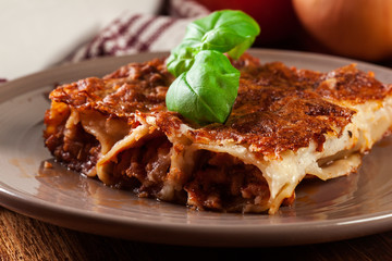 Baked cannelloni with minced meat and bechamel sauce on a plate