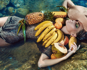 Conceptual portrait of a lady with tropical fruit