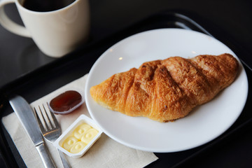 Croissant and coffee in coffee shop