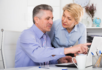 Colleagues look interesting in computer