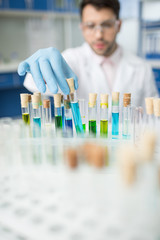 man scientist working with glass tubes in lab