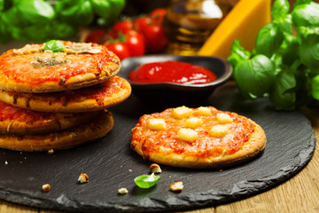 Mix of mini pizzas on a stone try