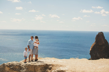 Happy family of four walking in the mountains. Family concept. Family trip.