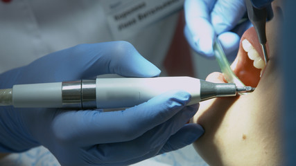 Patient for preventive medical checkup at dentist with probe and mirror