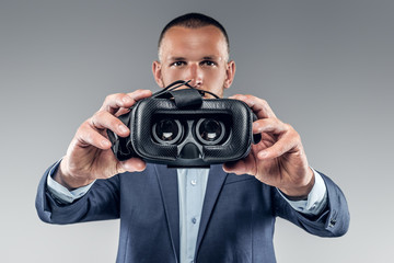 A man showing virtual reality glasses.