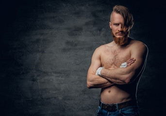 Brutal fighter with long hair over dark grey background.