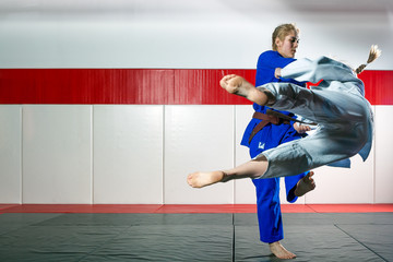 Two women fight judo on tatami
