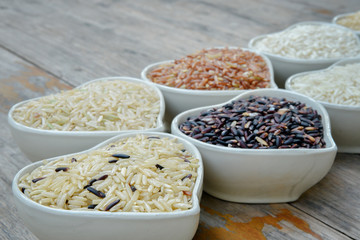 Prepared coarse rice and differrent rice on plank