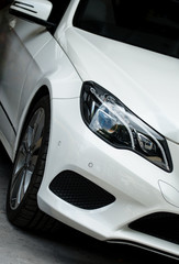 Fototapeta na wymiar Close-up view of white sports car headlight.