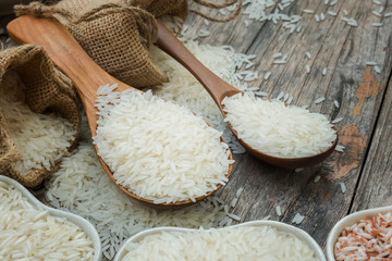Jasmine rice in wooden spoon on plank