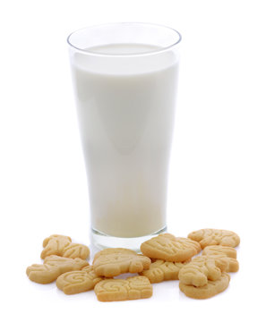 glass of milk and animals crackers on white background