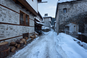 Winter scene. Along the narrow streets of Shiroka Laka village, Bulgaria in a sunny winter day
