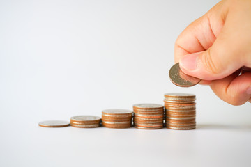 Money, Financial, Business Growth concept, stack of coins with Man's hand put money coins on white background with copyspace , Finance banking account and money currency saving background 