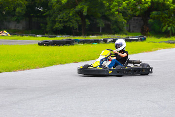 women drive karting car on outdoor track