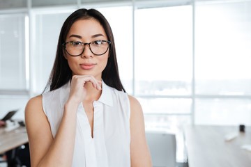 Portrait of beautiful asian young businesswoman standing in office