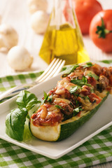 Zucchini stuffed with minced meat, cheese and mushroom. Baked in oven.