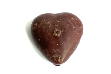 Chocolate covered gingerbread heart on a white background