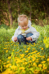 little girl on the dandelions meadow in spring day