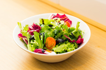 Healthy salad plate on a wooden table