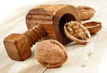 nutcracker with walnuts on aged wood