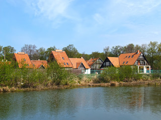 Naklejka na ściany i meble View of the cottage settlement on the bank of the lake. Kaliningrad region